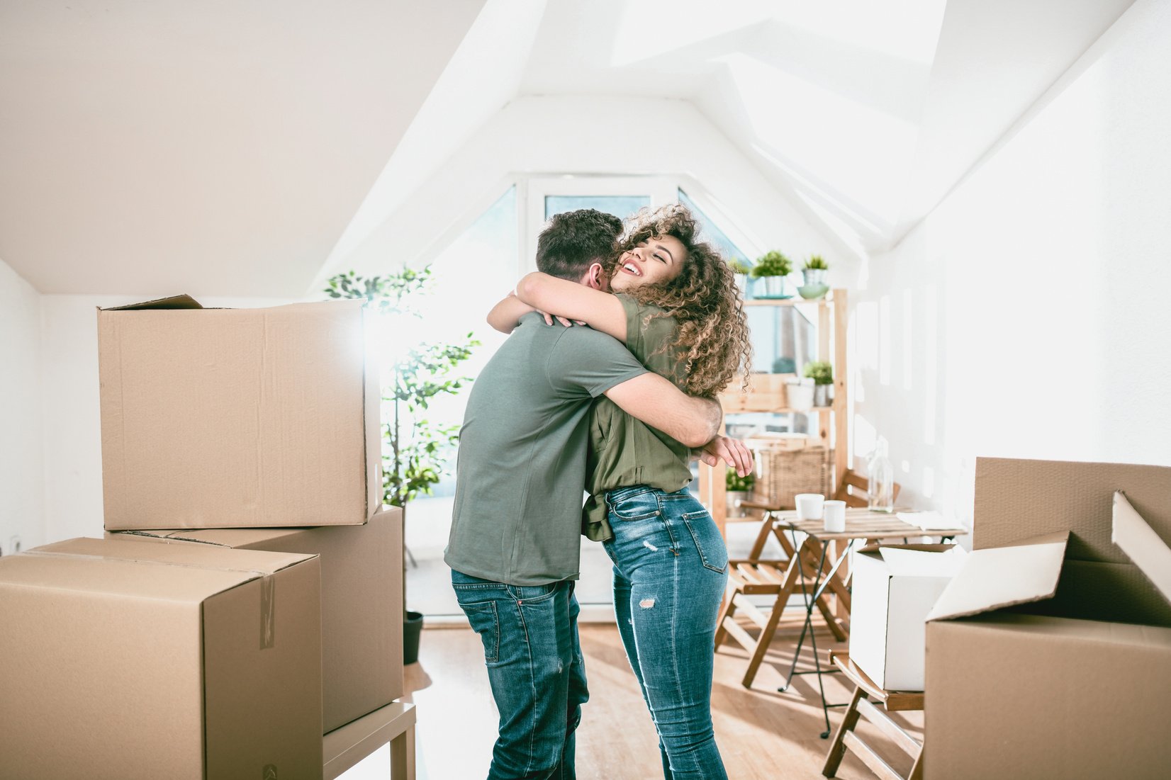 Happy Couple Embracing In New Living Place